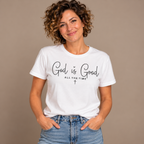 Woman wearing the White God Is Good All The Time T-Shirt, studio photo