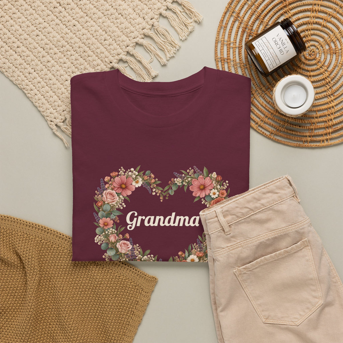Maroon Personalized Grandma T-Shirt With Grandkids Names in a flat lay with a knit sweater and jeans