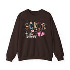 Dark Chocolate Scrub Life nurse sweatshirt with patterned lettering, stethoscope and clogs, front view