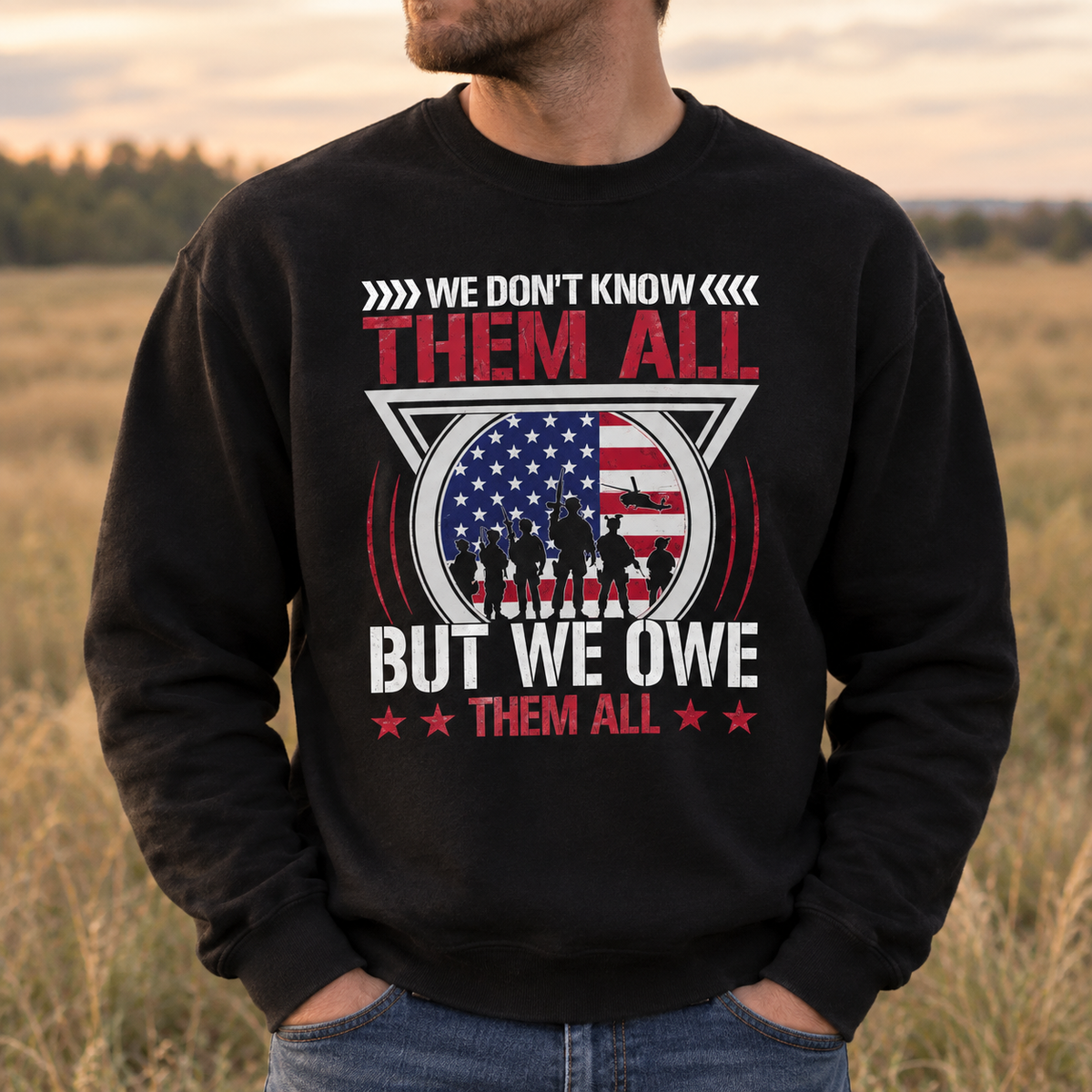 Model wearing the We Don't Know Them All But We Owe Them All Sweatshirt