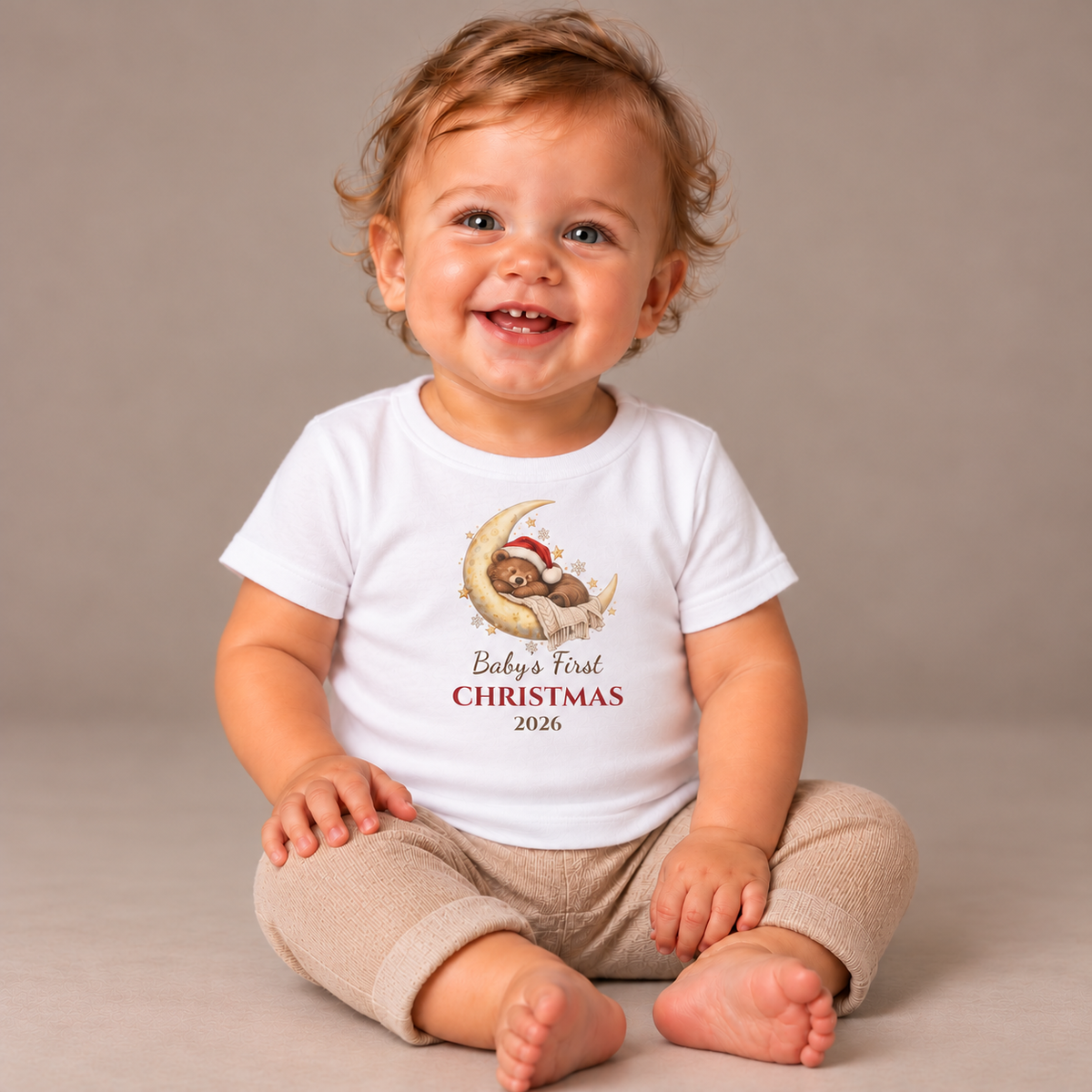 Baby wearing the White Baby's First Christmas 2026 Baby T-Shirt