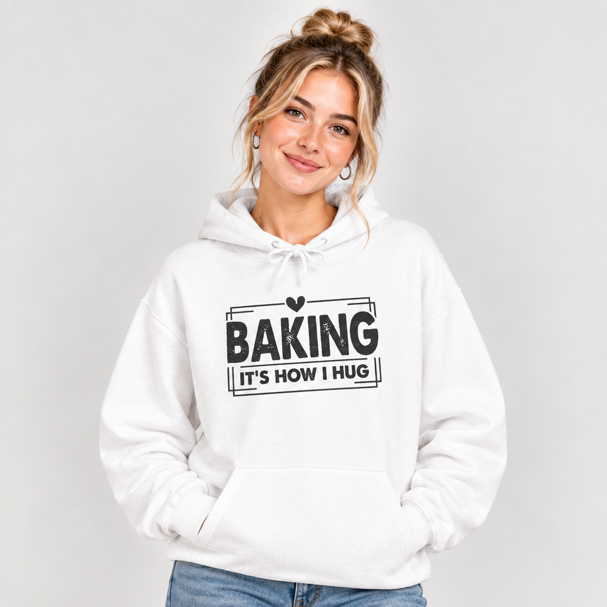 Woman wearing the white Baking It's How I Hug Black Print Hoodie with jeans