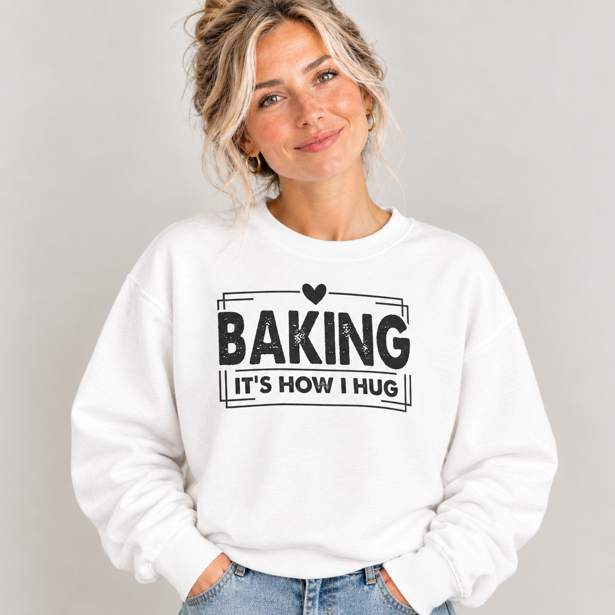 Woman wearing the white Baking It's How I Hug Black Print Sweatshirt with jeans