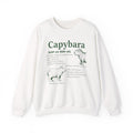 White Capybara Definition sweatshirt with a green vintage field-guide capybara print, front view