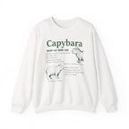 White Capybara Definition sweatshirt with a green vintage field-guide capybara print, front view