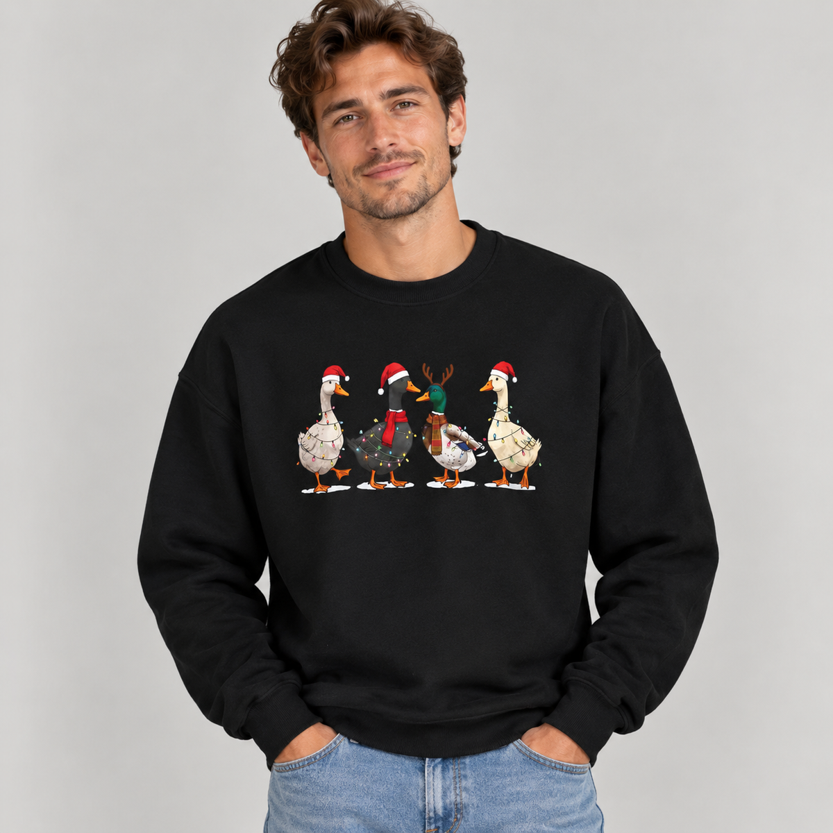 Man wearing the Black Christmas Geese In Santa Hats Sweatshirt with jeans