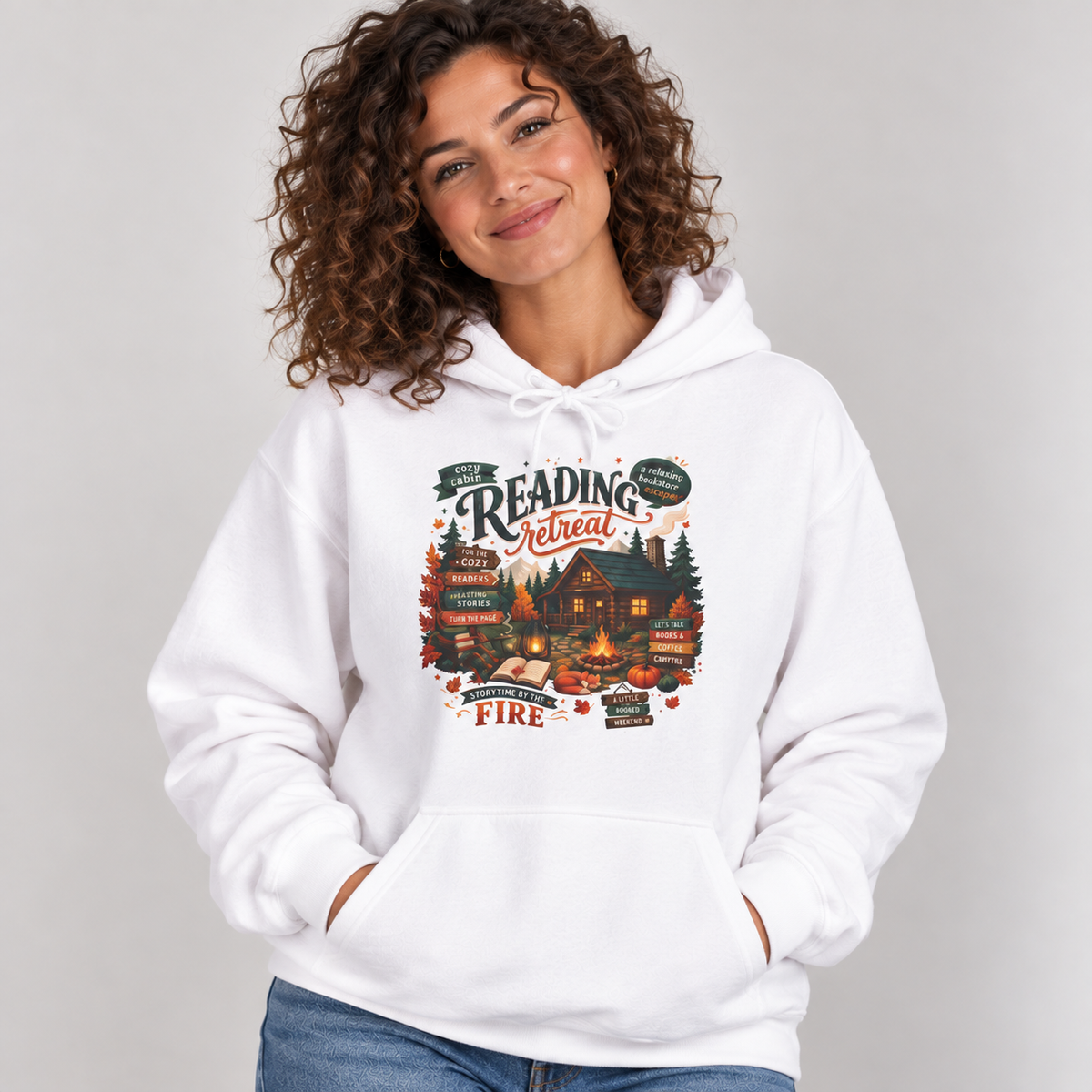 Woman wearing the White Cozy Cabin Reading Retreat Hoodie with jeans
