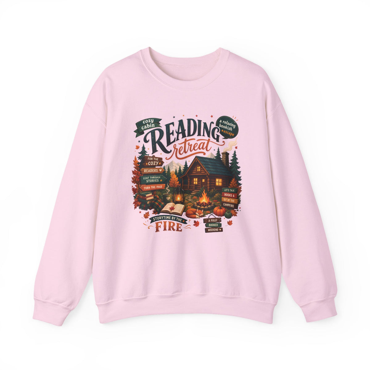 Light Pink Cozy Cabin Reading Retreat sweatshirt with a glowing log cabin in the pines, stacks of books and a crackling fire, front view