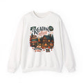 White Cozy Cabin Reading Retreat sweatshirt with a glowing log cabin in the pines, stacks of books and a crackling fire, front view