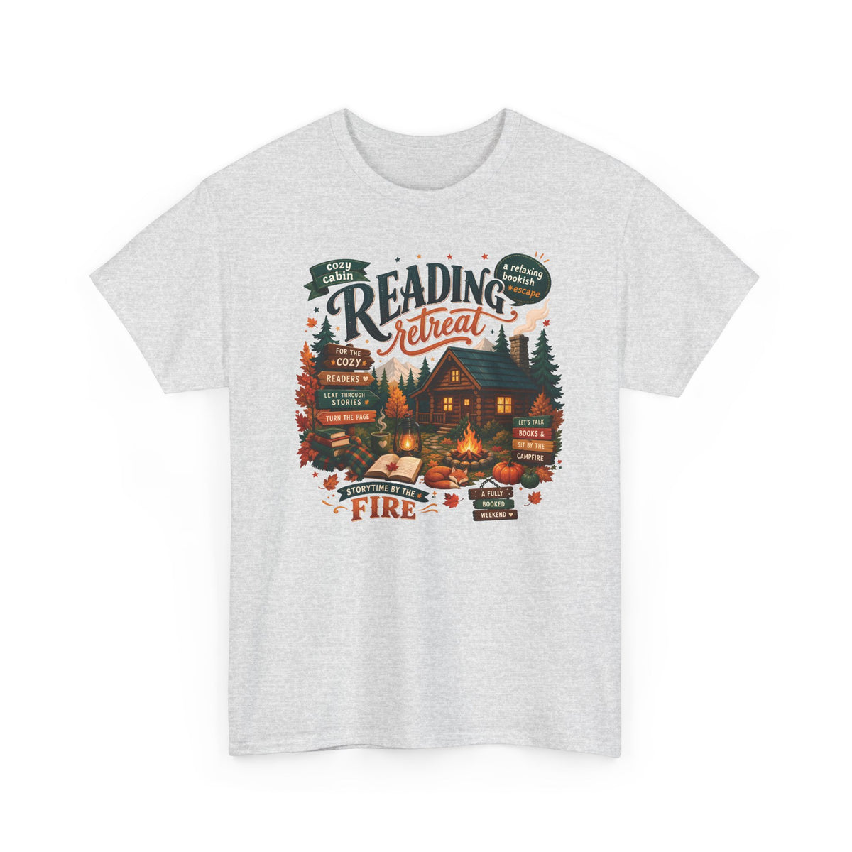 Ash Cozy Cabin Reading Retreat t-shirt with a glowing log cabin in the pines, stacks of books and a crackling fire, front view