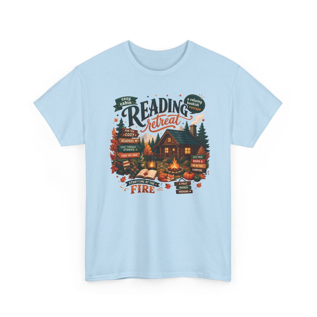 Light Blue Cozy Cabin Reading Retreat t-shirt with a glowing log cabin in the pines, stacks of books and a crackling fire, front view