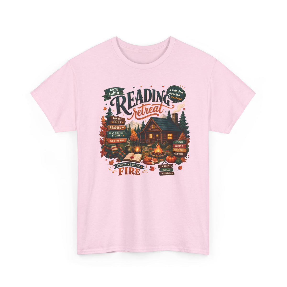 Light Pink Cozy Cabin Reading Retreat t-shirt with a glowing log cabin in the pines, stacks of books and a crackling fire, front view