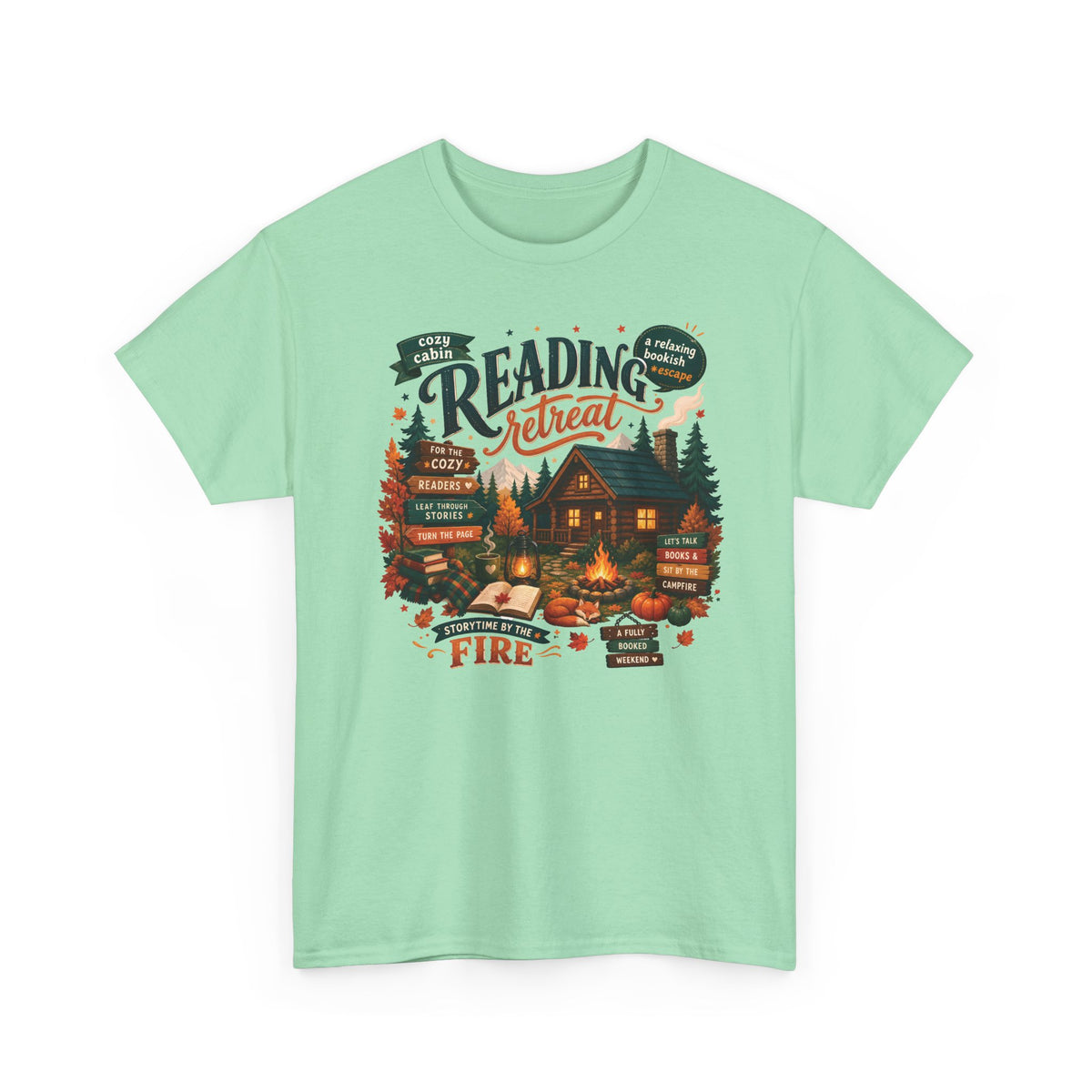 Mint Green Cozy Cabin Reading Retreat t-shirt with a glowing log cabin in the pines, stacks of books and a crackling fire, front view