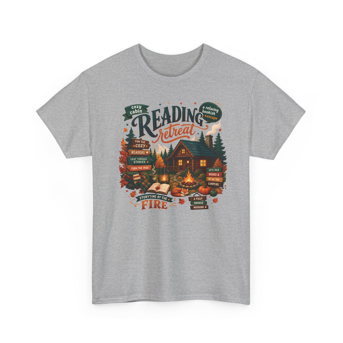 Sport Grey Cozy Cabin Reading Retreat t-shirt with a glowing log cabin in the pines, stacks of books and a crackling fire, front view