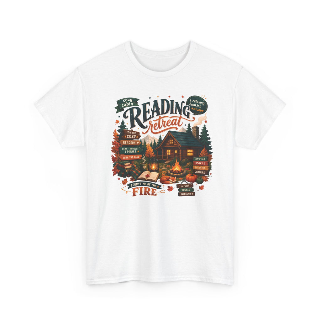 White Cozy Cabin Reading Retreat t-shirt with a glowing log cabin in the pines, stacks of books and a crackling fire, front view