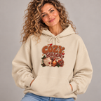 Woman wearing the Sand Cozy Season Hoodie with jeans