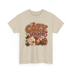 Sand Cozy Season t-shirt with cable-knit lettering, hot cocoa, a candle and a plaid blanket, front view