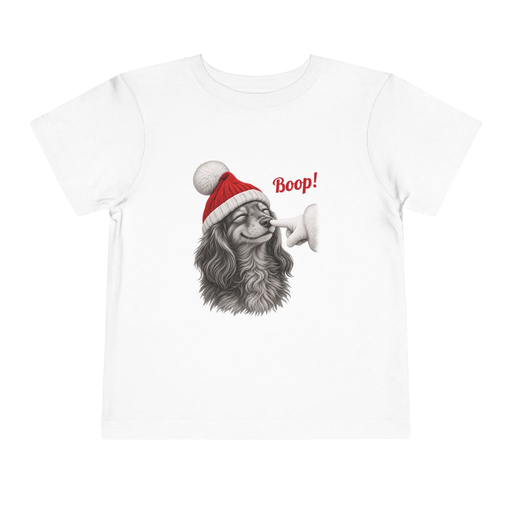 White Dachshund Boop Christmas toddler t-shirt with a smiling dachshund in a Santa hat getting a nose boop, front view