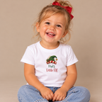 Girl wearing the White Dad's Little Elf Baby T-Shirt
