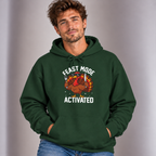 Man wearing the Forest Green Feast Mode Activated Hoodie with jeans