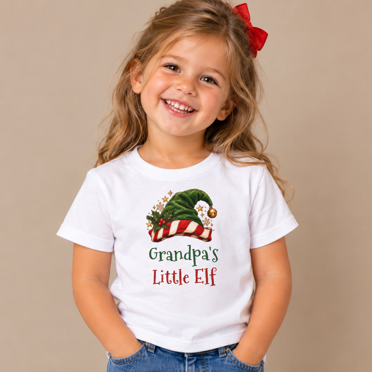 Girl wearing the White Grandpa's Little Elf Kids T-Shirt
