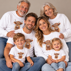 Three generations wearing matching Highland Cow With Christmas Lights sweatshirts, t-shirts and a baby bodysuit