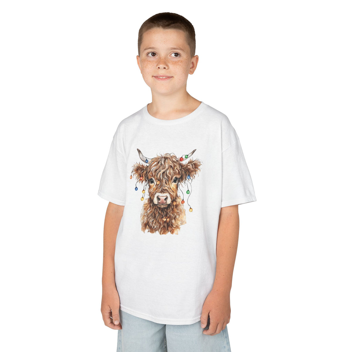 Boy wearing the White Highland Cow With Christmas Lights Kids T-Shirt