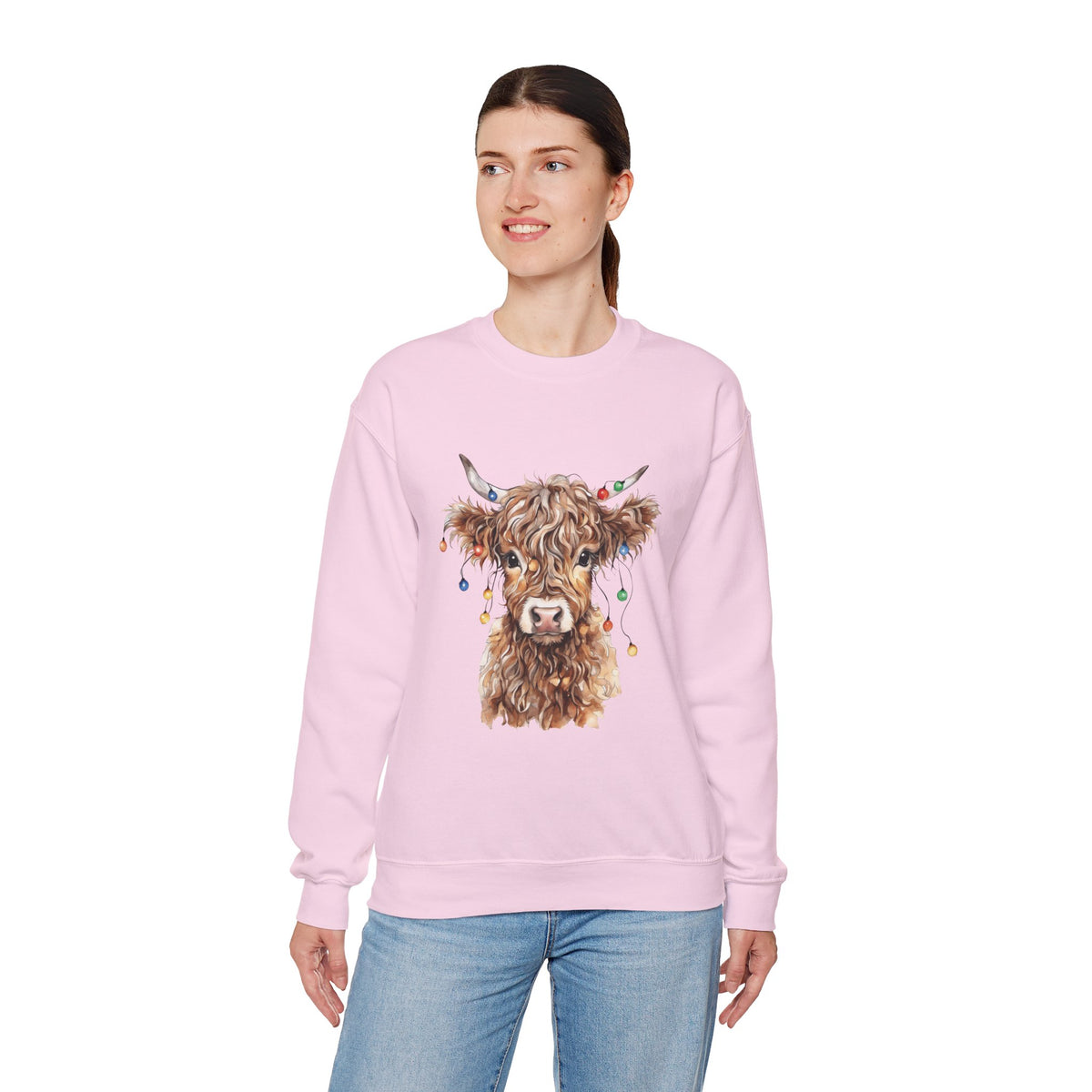 Woman wearing the Light Pink Highland Cow With Christmas Lights Sweatshirt