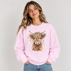 Woman wearing the Light Pink Highland Cow With Christmas Lights Sweatshirt with jeans