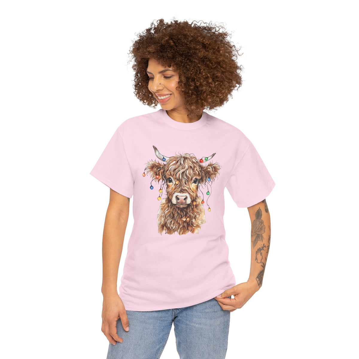 Woman wearing the Light Pink Highland Cow With Christmas Lights T-Shirt
