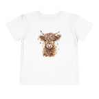 White Highland Cow With Christmas Lights toddler t-shirt with a watercolor highland cow wearing colorful Christmas lights, front view