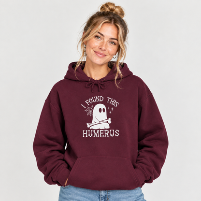 Woman wearing the I Found This Humerus ghost hoodie, hands in pocket