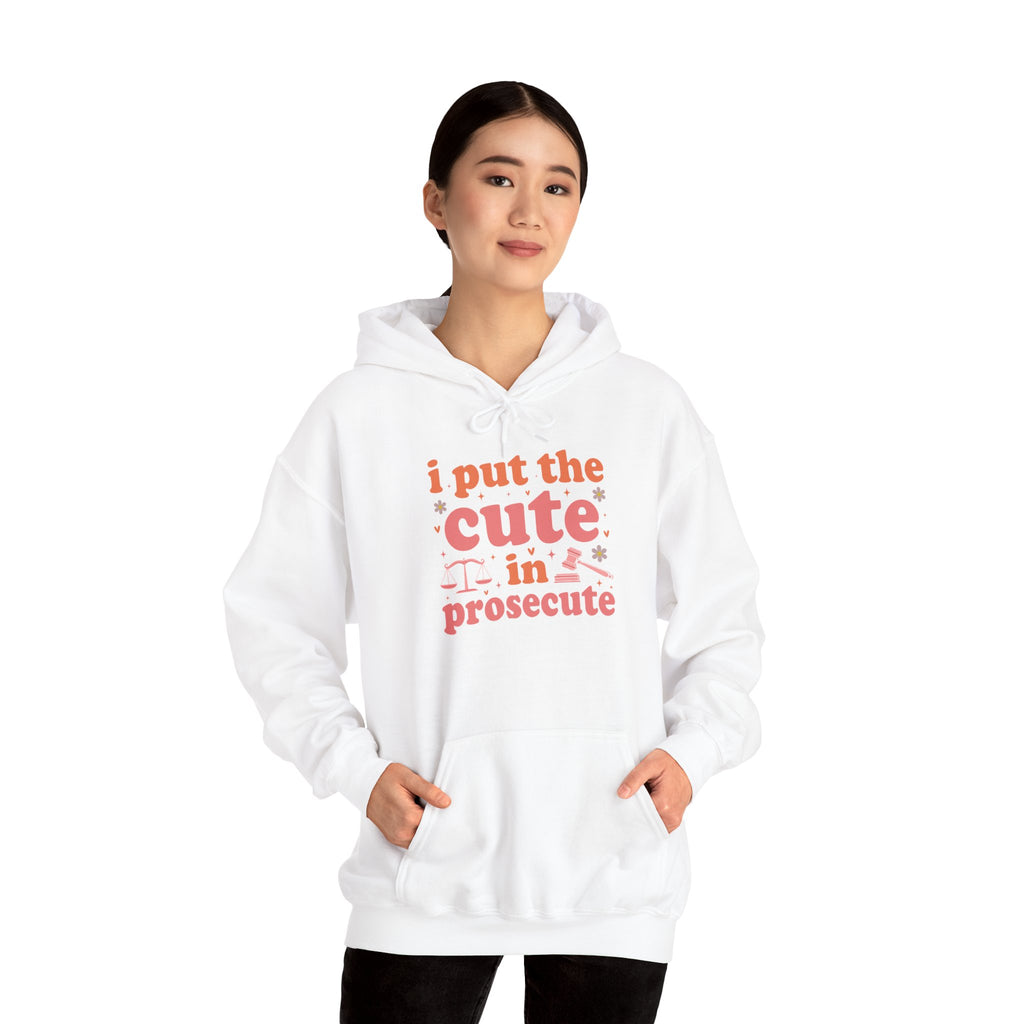 Woman wearing the I Put The Cute In Prosecute lawyer hoodie, hands in pocket