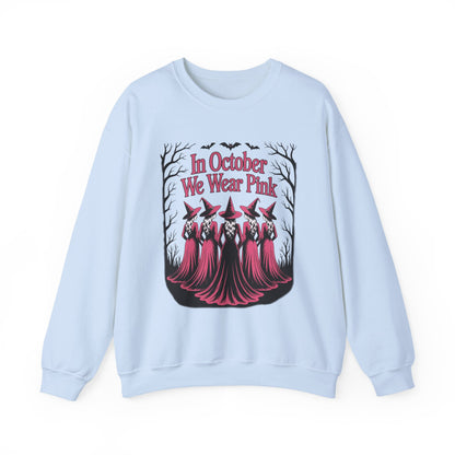 Light blue In October We Wear Pink sweatshirt with five witches in pink gowns