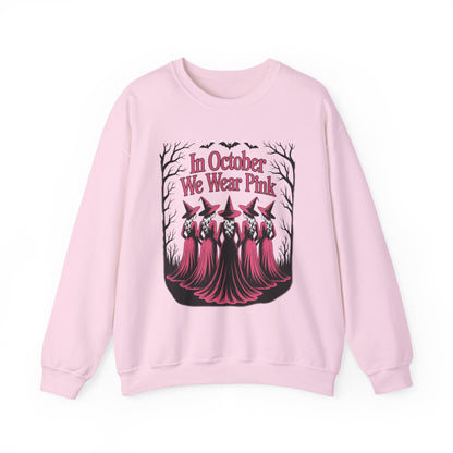 Light pink In October We Wear Pink sweatshirt with five witches in pink gowns