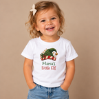 Girl wearing the White Mama's Little Elf Baby T-Shirt