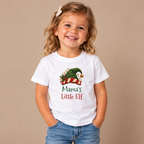 Girl wearing the White Mama's Little Elf Toddler T-Shirt