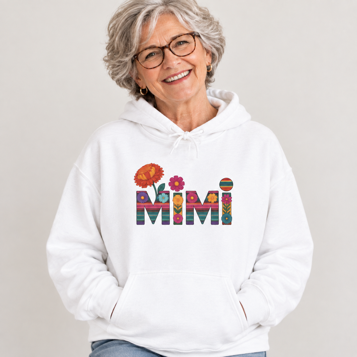Woman wearing the Mimi floral serape lettering hoodie