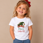 Girl wearing the White Mimi's Little Elf Toddler T-Shirt