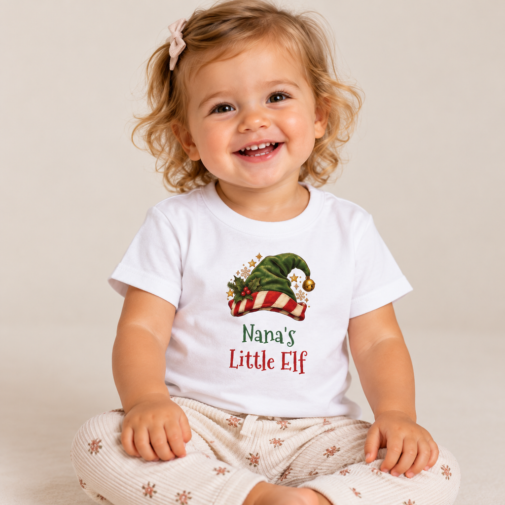 Girl wearing the White Nana's Little Elf Baby T-Shirt