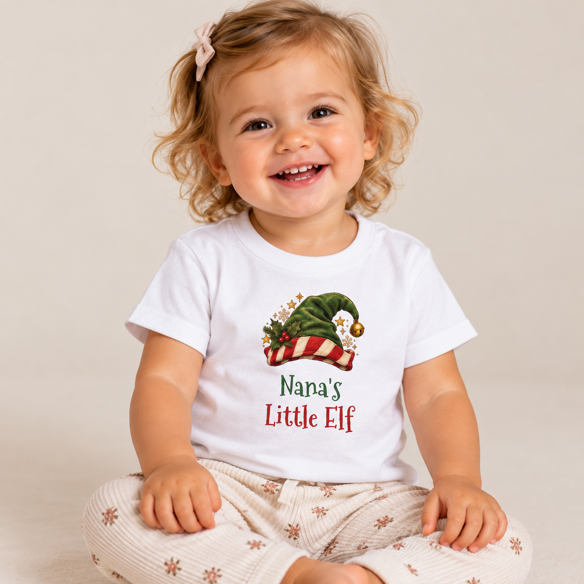 Girl wearing the White Nana's Little Elf Baby T-Shirt