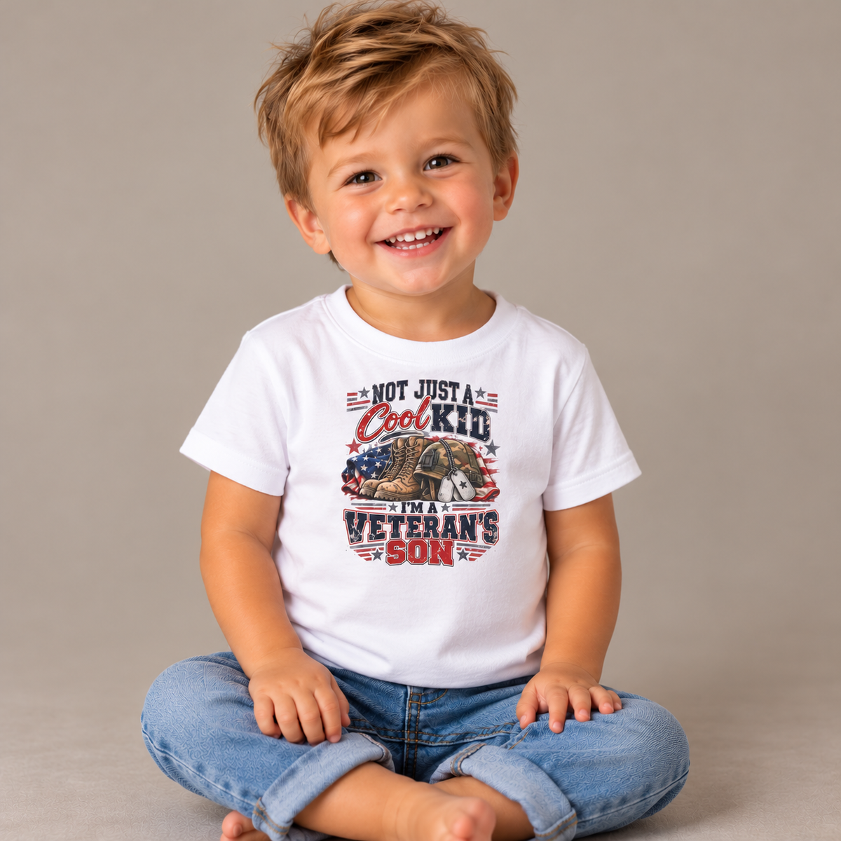 Baby wearing the White Not Just A Cool Kid I'm A Veteran's Son Baby T-Shirt