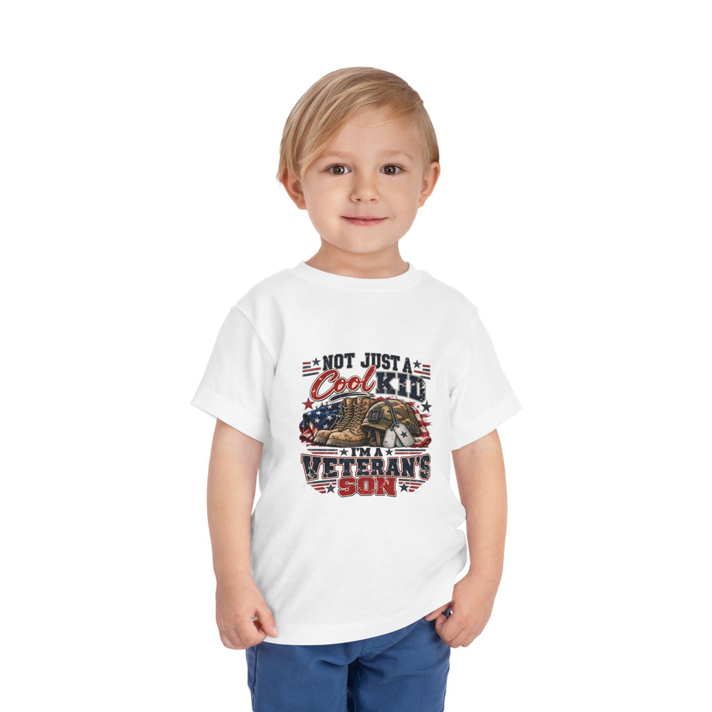 Toddler wearing the white Not Just A Cool Kid I'm A Veteran's Son Toddler T-Shirt