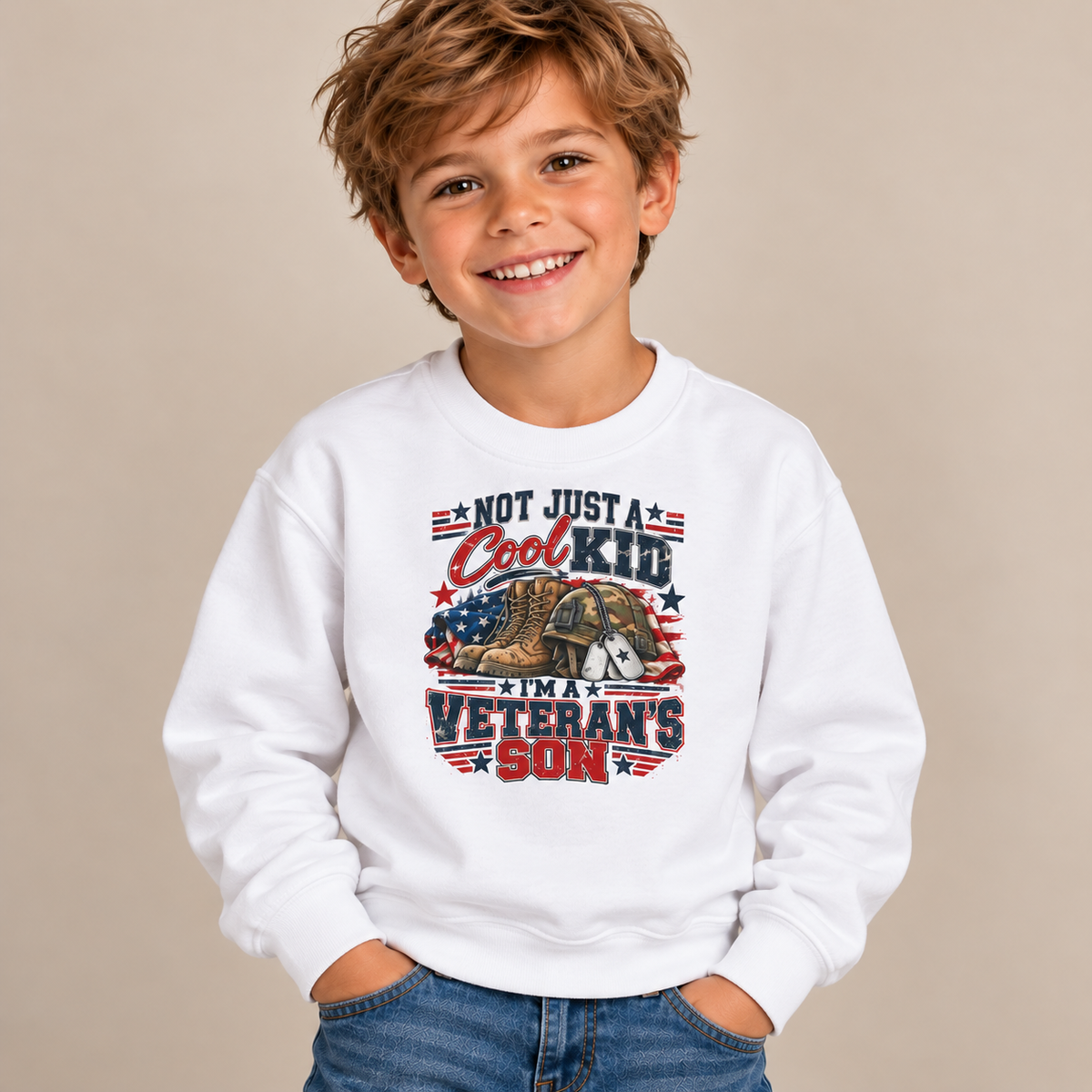 Boy wearing the White Not Just A Cool Kid I'm A Veteran's Son Youth Sweatshirt with jeans