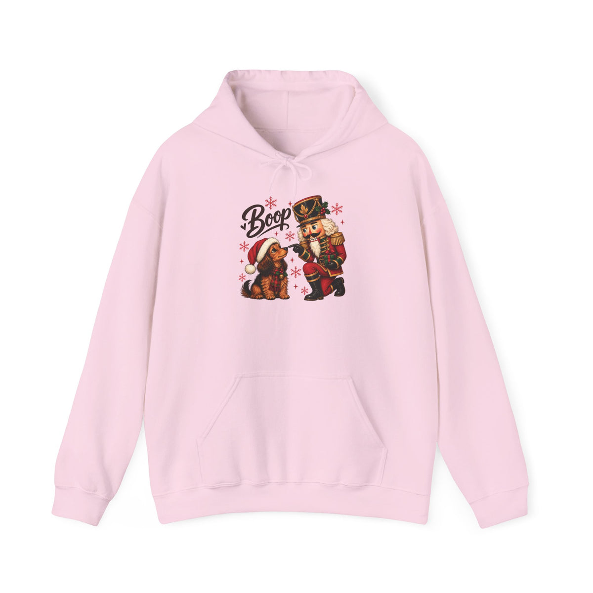 Light Pink Nutcracker Dachshund Boop Christmas hoodie with a nutcracker soldier booping the nose of a dachshund in a Santa hat, front view