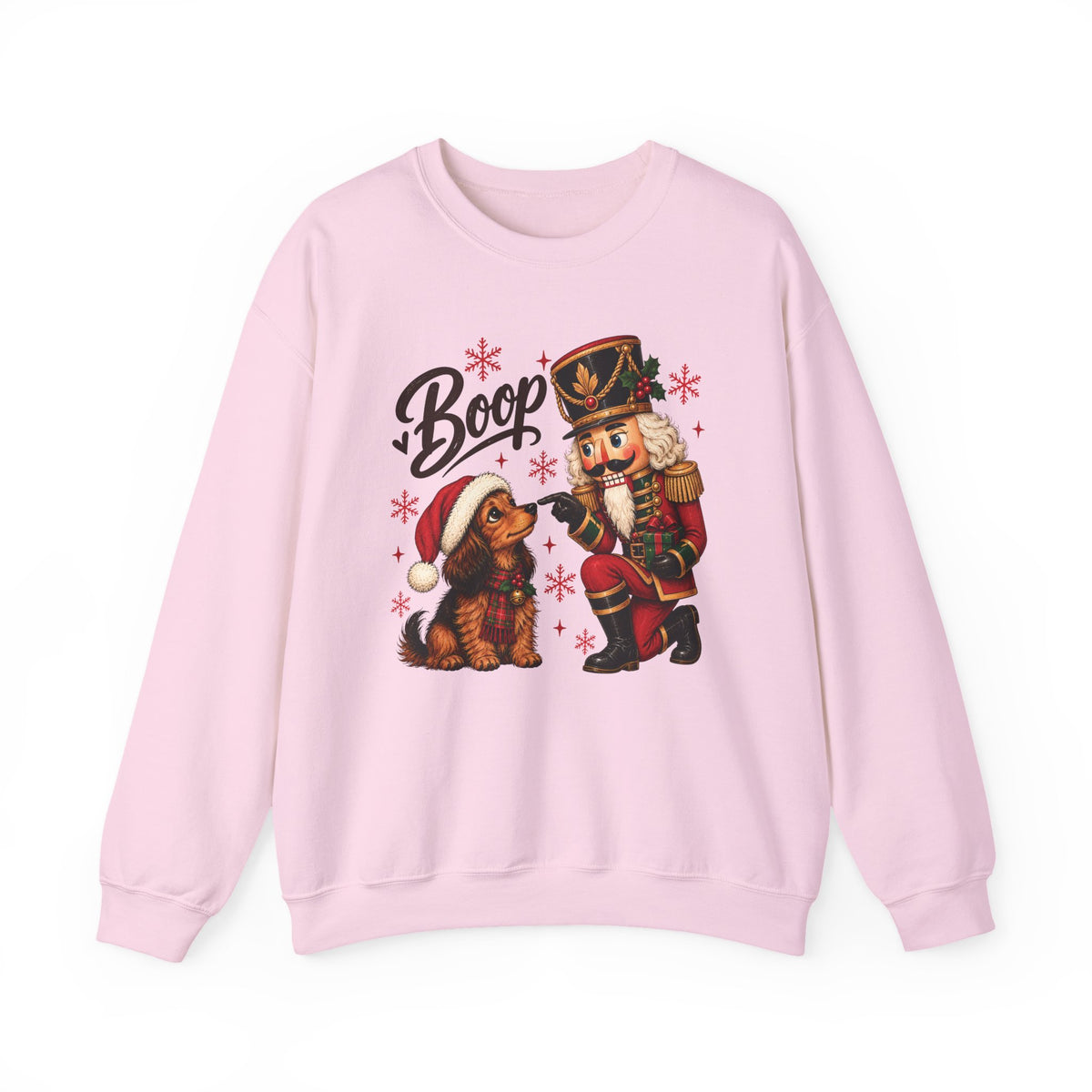 Light Pink Nutcracker Dachshund Boop Christmas sweatshirt with a nutcracker soldier booping the nose of a dachshund in a Santa hat, front view