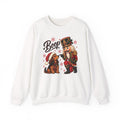 White Nutcracker Dachshund Boop Christmas sweatshirt with a nutcracker soldier booping the nose of a dachshund in a Santa hat, front view