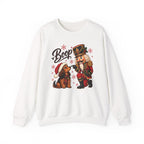 White Nutcracker Dachshund Boop Christmas sweatshirt with a nutcracker soldier booping the nose of a dachshund in a Santa hat, front view