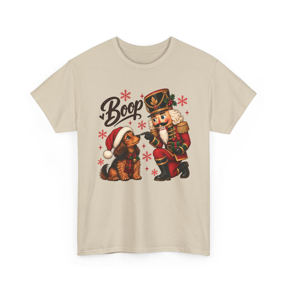 Sand Nutcracker Dachshund Boop Christmas t-shirt with a nutcracker soldier booping the nose of a dachshund in a Santa hat, front view