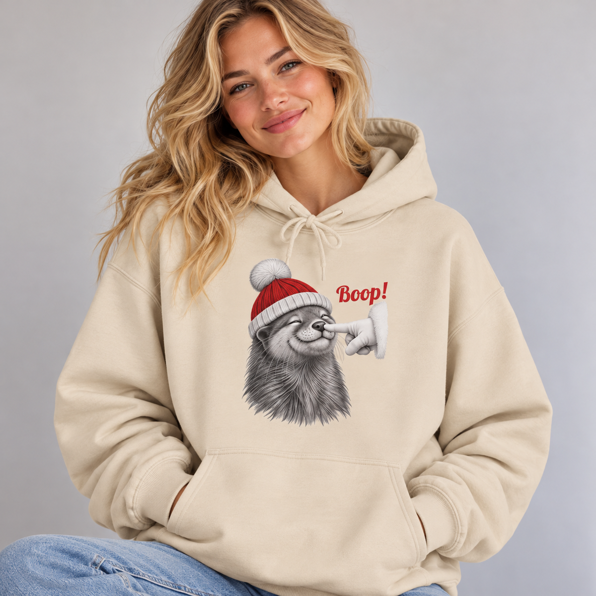Woman wearing the Sand Otter Boop Christmas Hoodie with jeans